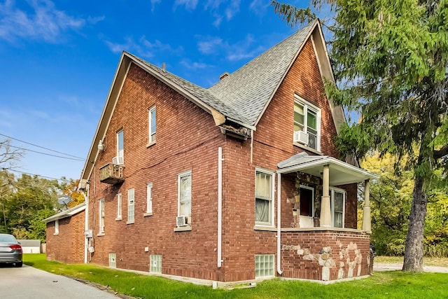 view of side of home featuring a lawn