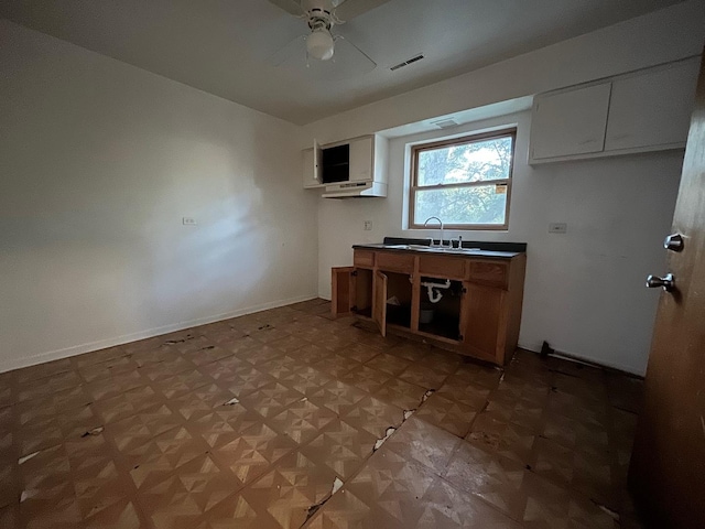 kitchen featuring white cabinetry, parquet floors, ceiling fan, and sink