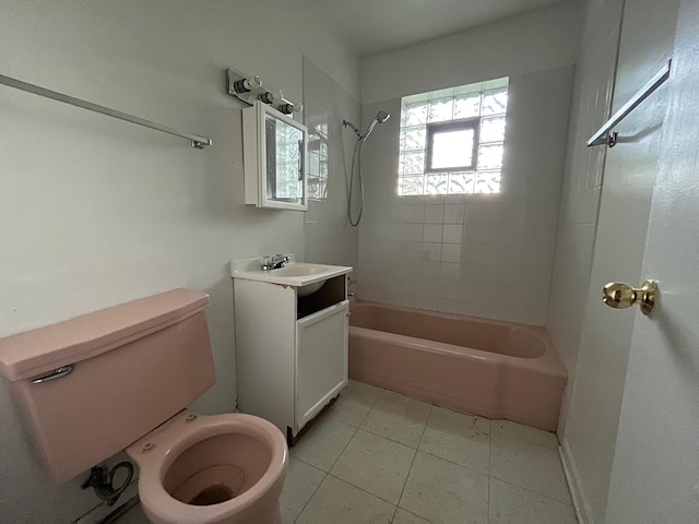 full bathroom featuring tile floors, toilet, vanity, and tiled shower / bath