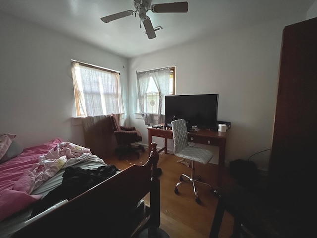 bedroom with hardwood / wood-style floors and ceiling fan