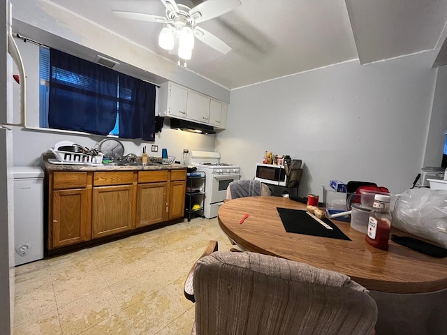 kitchen with ceiling fan, gas stove, and light tile floors