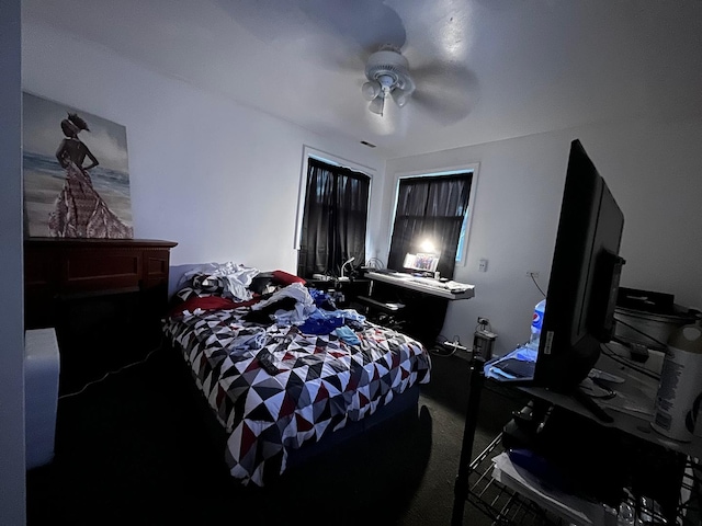 bedroom featuring ceiling fan and dark colored carpet