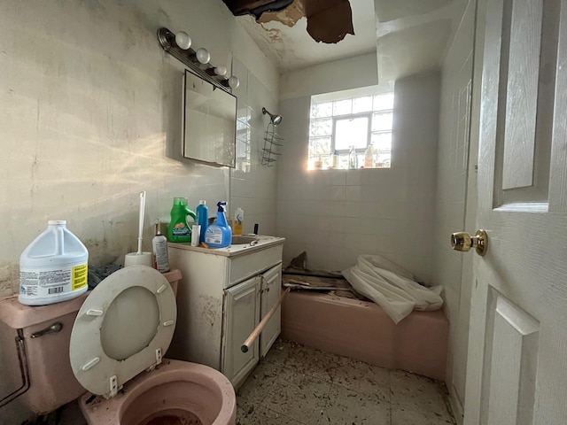 bathroom with tile flooring, toilet, and vanity with extensive cabinet space