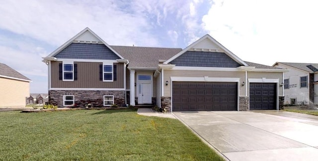 view of front facade featuring a front lawn, stone siding, driveway, and an attached garage