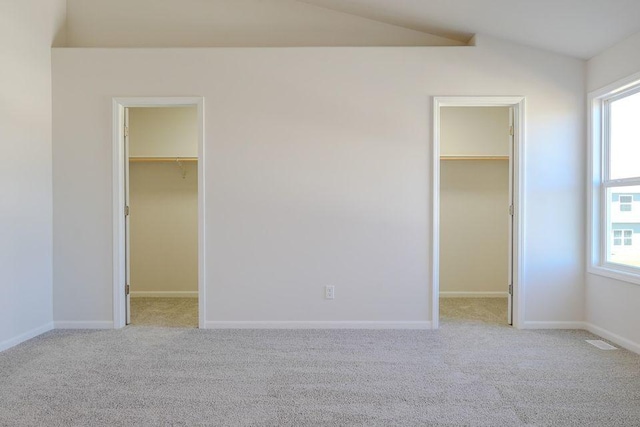 8357 Dylan Dr, Merrillville, IN 46410 - unfurnished bedroom with a walk in closet, a closet, visible vents, and lofted ceiling