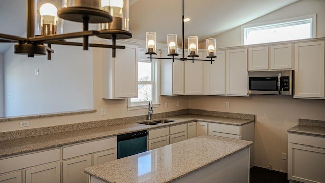 8357 Dylan Dr, Merrillville, IN 46410 - kitchen featuring stainless steel microwave, vaulted ceiling, a sink, light stone countertops, and dishwasher