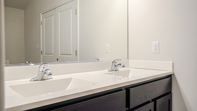 full bathroom with double vanity and a sink