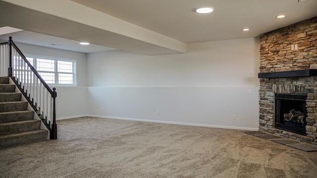 unfurnished living room featuring recessed lighting, a fireplace, baseboards, stairs, and carpet