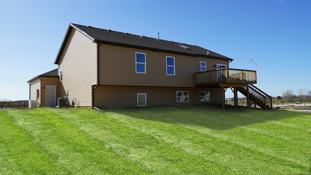 back of house featuring central AC, stairway, a lawn, and a wooden deck