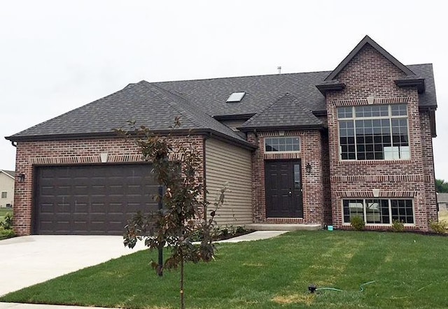 view of front of home featuring an attached garage, a front lawn, and brick siding