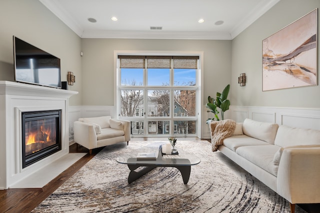 living room featuring dark hardwood / wood-style flooring and ornamental molding