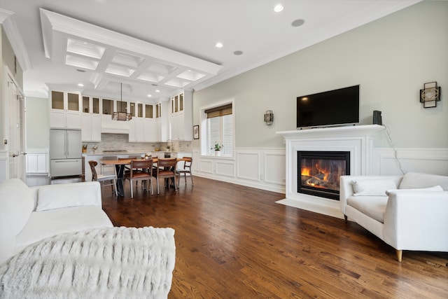 living room featuring coffered ceiling, beam ceiling, dark wood-type flooring, crown molding, and sink