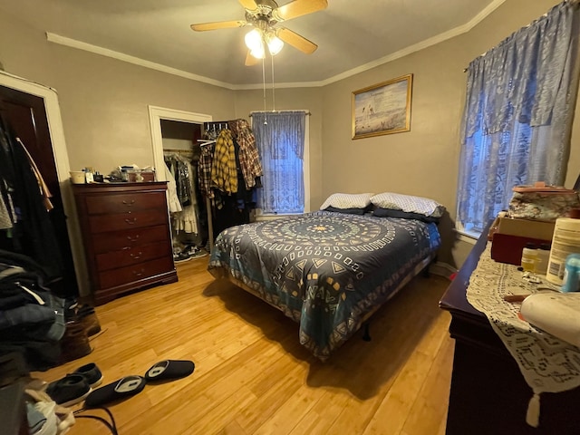 bedroom featuring ceiling fan, a closet, ornamental molding, and light hardwood / wood-style floors