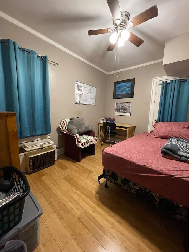 bedroom featuring ornamental molding, ceiling fan, and light wood-type flooring