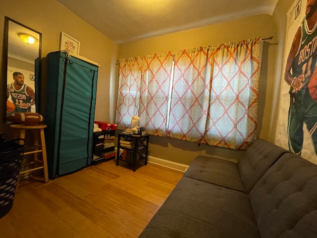 sitting room featuring lofted ceiling and light hardwood / wood-style floors