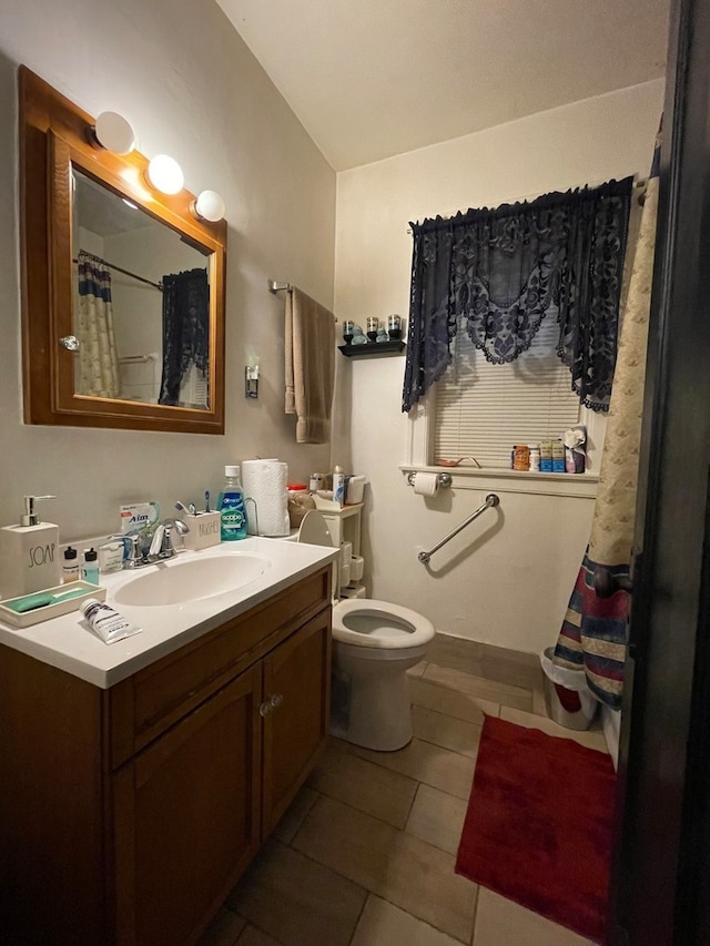 bathroom with oversized vanity, toilet, and tile floors