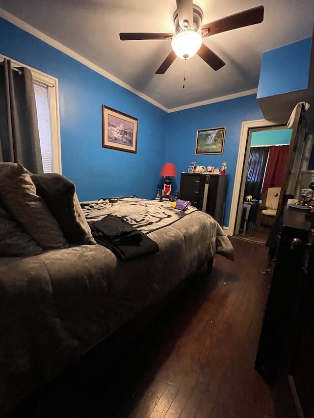 bedroom with crown molding, dark hardwood / wood-style flooring, and ceiling fan