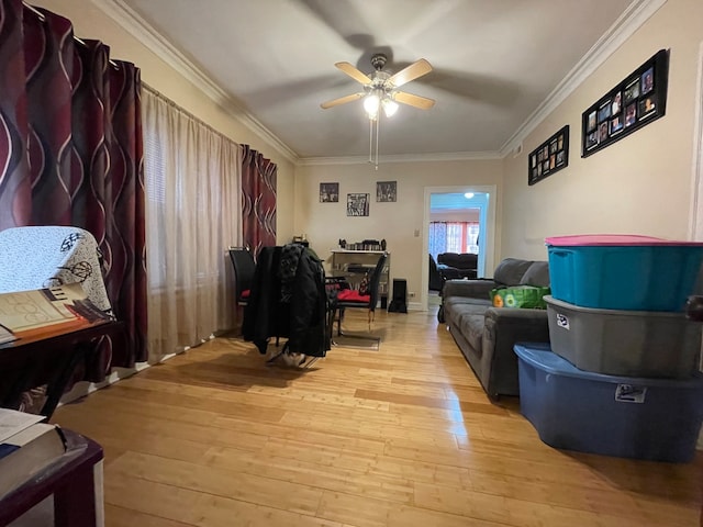 living room with ceiling fan, light wood-type flooring, and ornamental molding