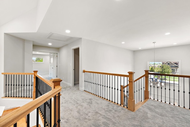 hall featuring an upstairs landing, carpet, recessed lighting, baseboards, and attic access