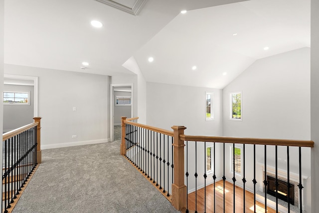 hallway featuring an upstairs landing, recessed lighting, lofted ceiling, and baseboards