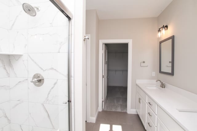 bathroom with tile flooring, tiled shower, and oversized vanity