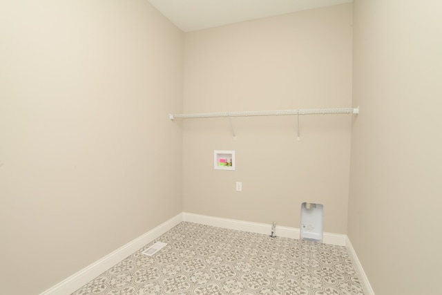 laundry room featuring hookup for a washing machine and light tile flooring