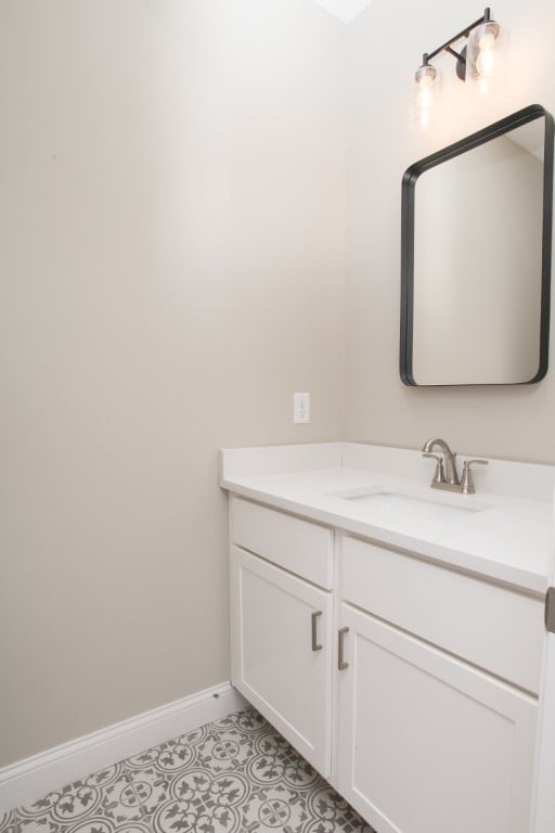 bathroom with tile flooring and vanity