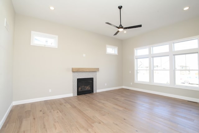 unfurnished living room featuring ceiling fan and light hardwood / wood-style flooring