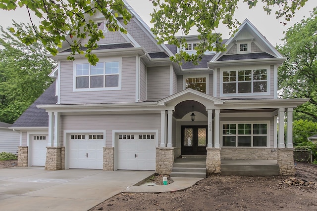 craftsman inspired home with a porch and a garage