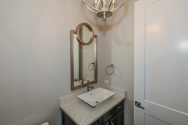 bathroom with an inviting chandelier and vanity