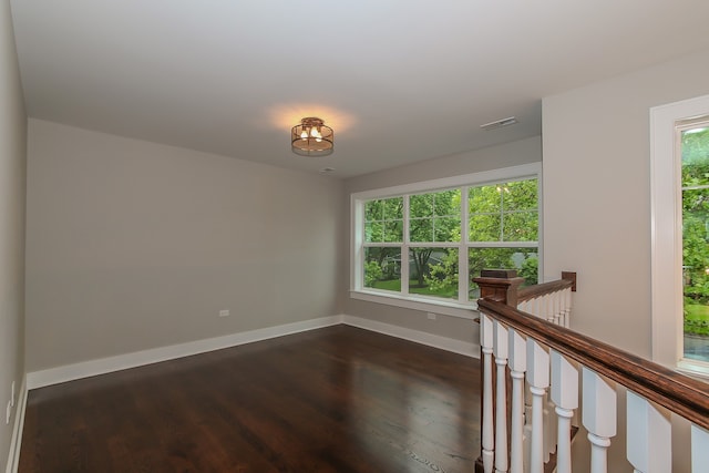 empty room with dark hardwood / wood-style floors