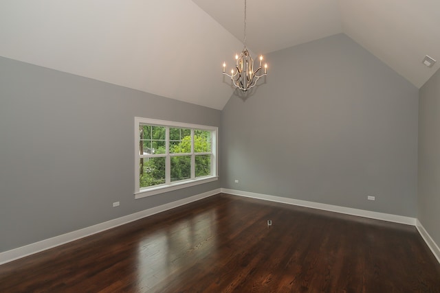 unfurnished room with lofted ceiling, dark wood-type flooring, and a chandelier