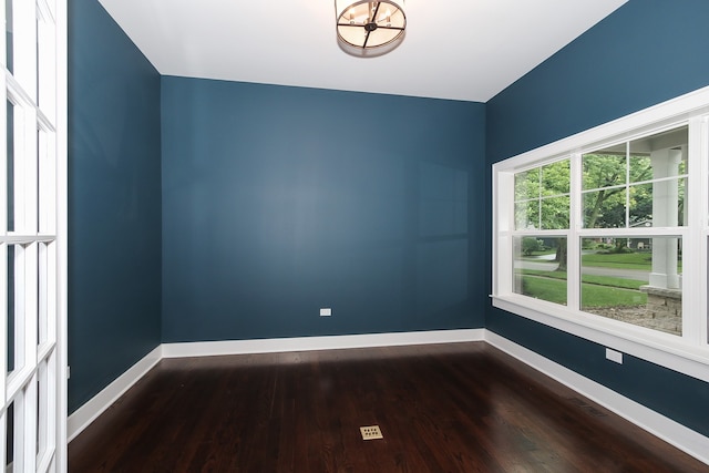 empty room with dark hardwood / wood-style flooring