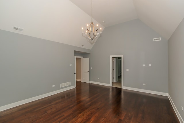 empty room featuring a notable chandelier, high vaulted ceiling, and dark hardwood / wood-style floors