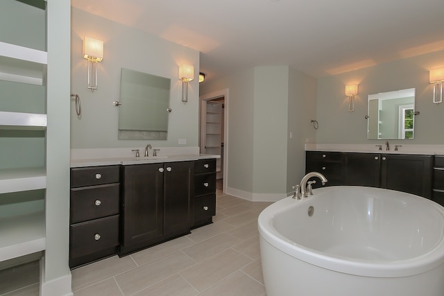 bathroom featuring double vanity, tile floors, and a bathing tub