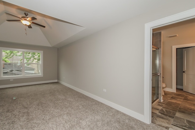 carpeted empty room featuring ceiling fan and lofted ceiling