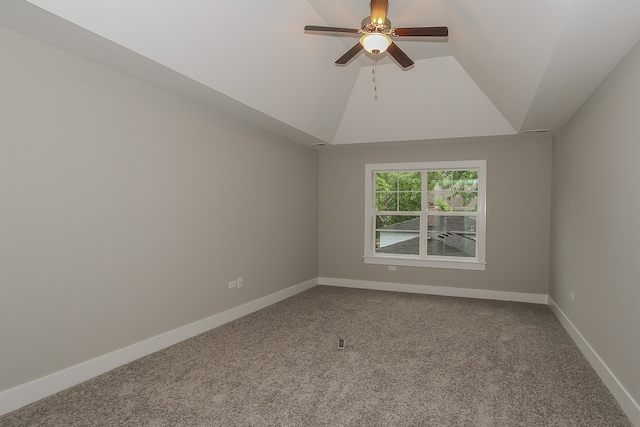 carpeted empty room with ceiling fan and vaulted ceiling