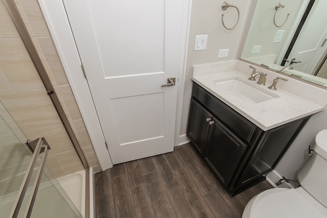 bathroom with oversized vanity, toilet, and wood-type flooring