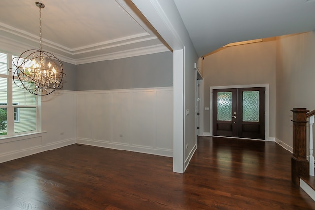 entryway featuring a notable chandelier, french doors, crown molding, a tray ceiling, and dark hardwood / wood-style floors