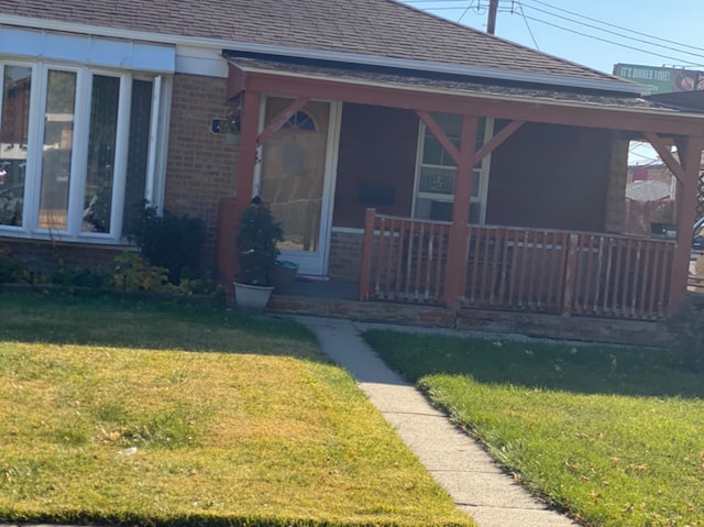 exterior space with a porch and a front lawn