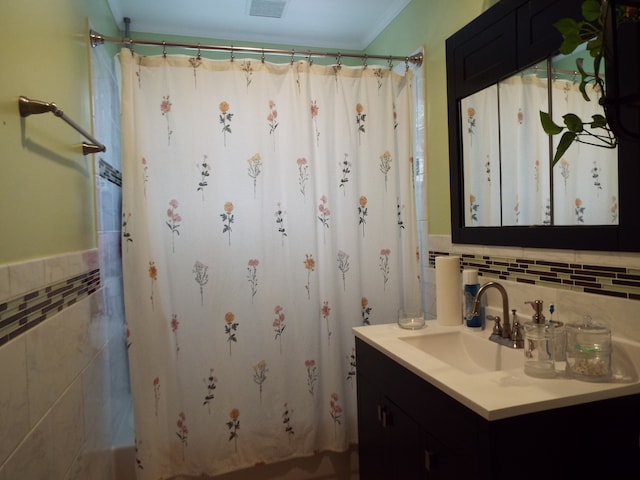 bathroom featuring backsplash, tile walls, and oversized vanity