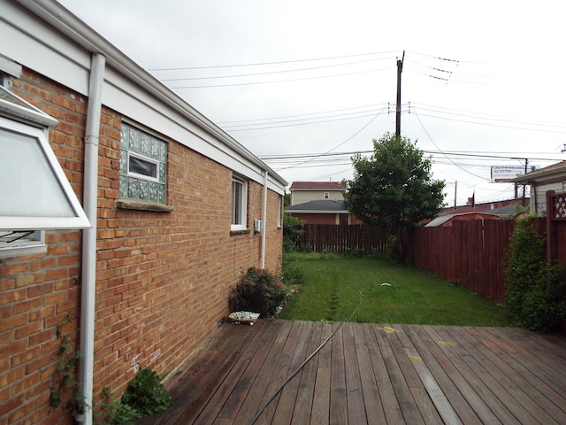 wooden deck featuring a yard