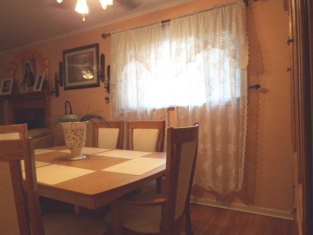 dining room featuring ornamental molding, dark hardwood / wood-style flooring, and ceiling fan