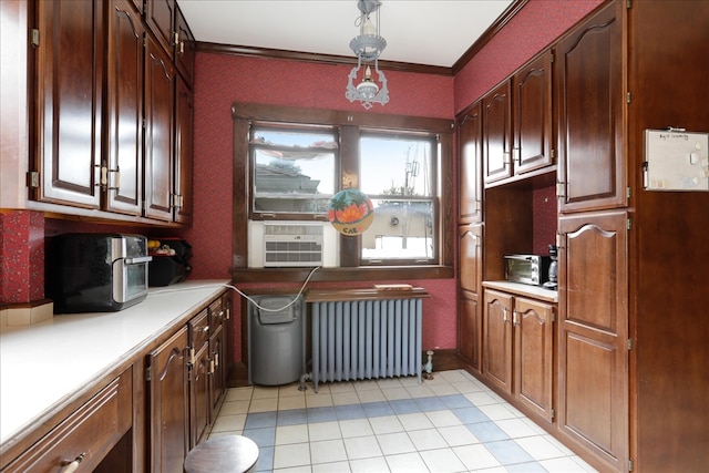 clothes washing area with crown molding, cooling unit, radiator heating unit, and light tile patterned floors