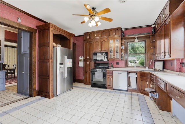 kitchen with black appliances, light tile patterned flooring, sink, ceiling fan, and ornamental molding