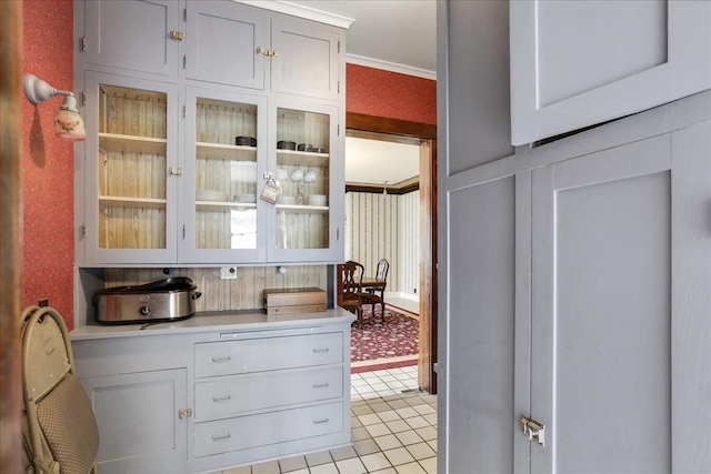 kitchen with crown molding and light tile patterned floors