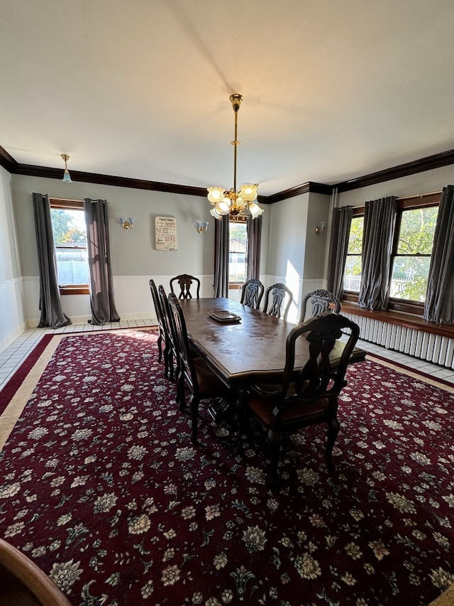 dining space featuring a notable chandelier, ornamental molding, and a wealth of natural light