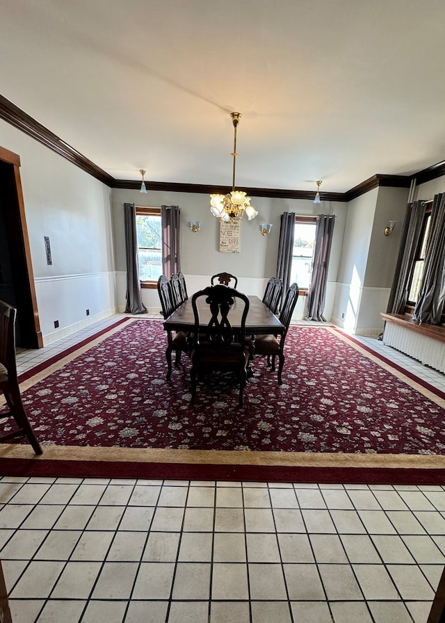 dining space featuring ornamental molding and a chandelier