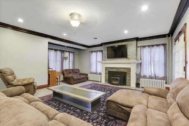 living room featuring ornamental molding, radiator heating unit, and a wealth of natural light