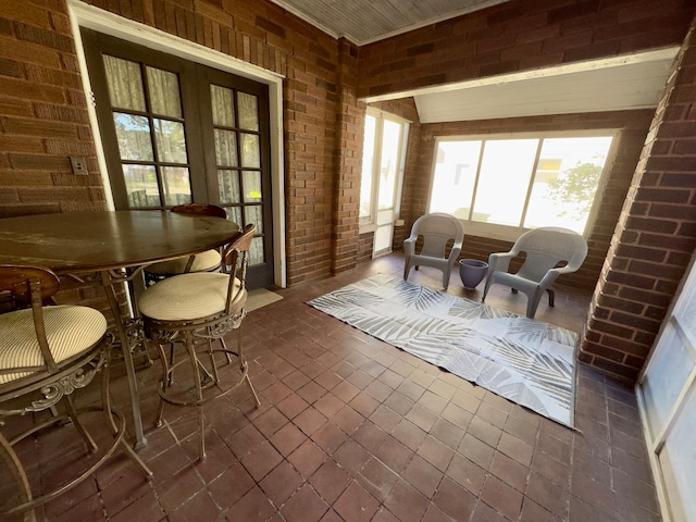 interior space with brick wall and french doors